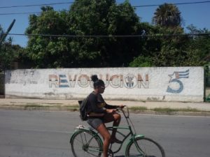 Woman riding a bike in Cienfuegos on Cuba