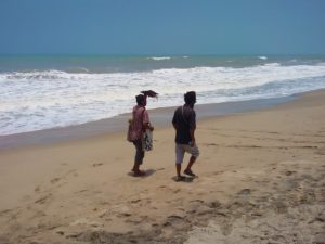 Two men walking on the beach of Palomino, Colombia