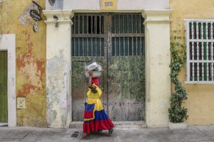 Woman in traditional clothing walking on a street in Cartagena