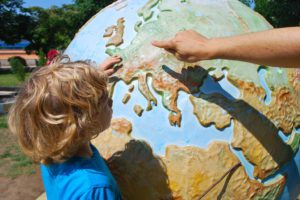 Child with a Globe illustrating Amazing Opportunities: It's never too late to become an Au Pair