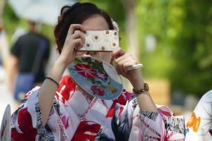 Geisha taking picture with a cellphone