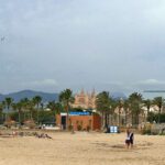 Beach at Palma de Mallorca with a view of the city.