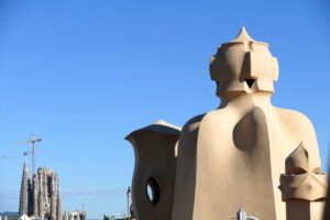 Gaudi's two most iconic works in together: The chimneys of the Casa Mila with the Sagrada Familia in the backdrop.