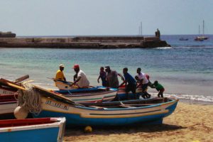 Fishermen pulling boat on shore in Tarrafal, Cape Verde