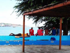 Men overlooking the Bay at the city of Praia on the island of Santiago, Cape Verde