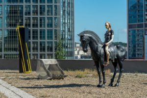Halil Daşkesen: Articulate, Meliha Sözeri: Cave, and Mahmut Aydın: Female Don Kişot against of the backdrop of the financial district's skyscraper skyline. Photo: Kayhan Kaygusuz